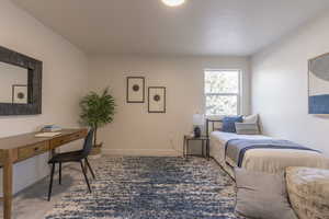Bedroom featuring baseboards and carpet flooring