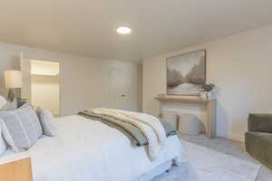 Bedroom featuring carpet and a spacious closet