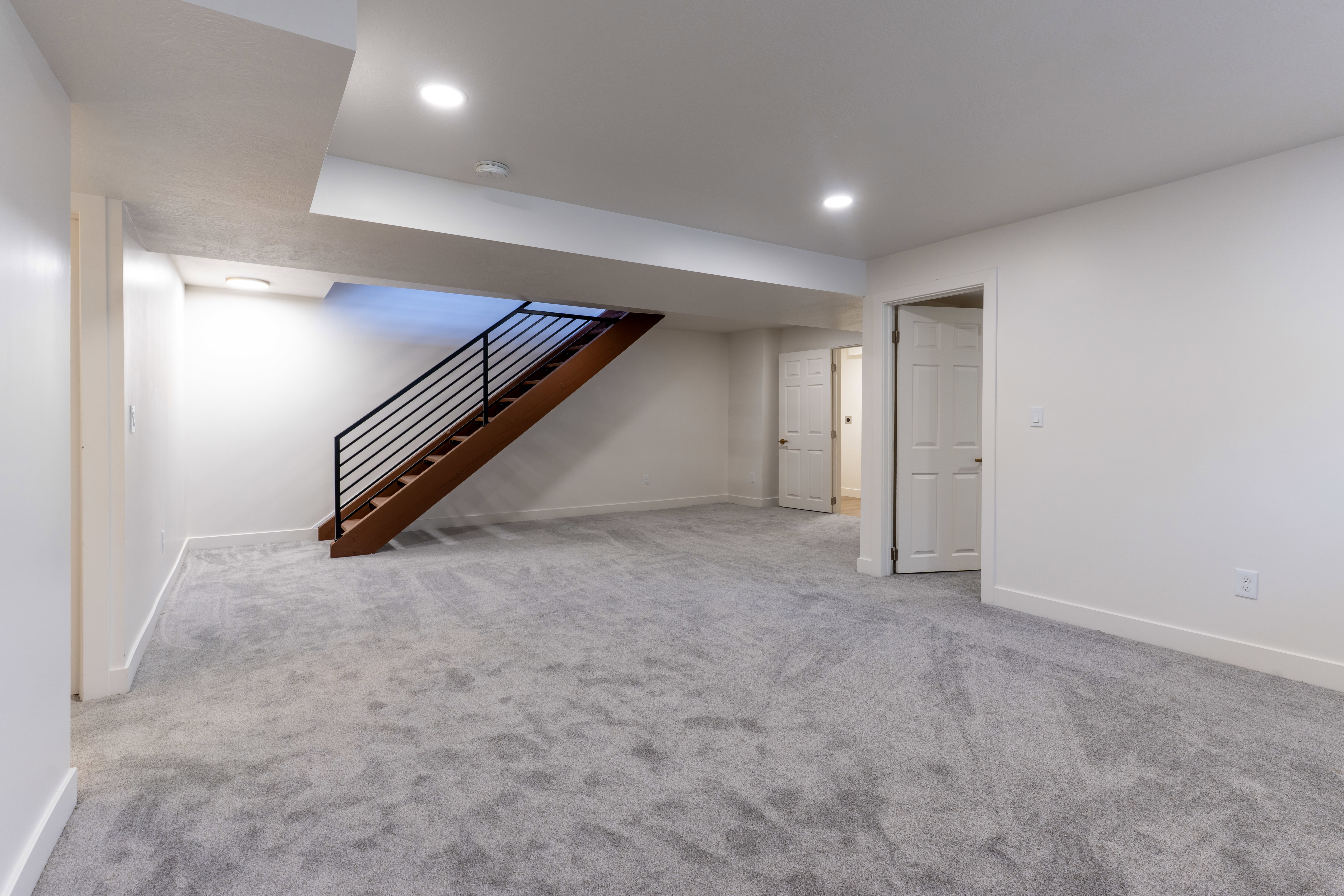 Finished below grade area featuring light carpet and recessed lighting