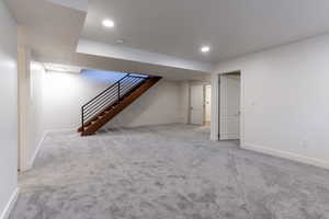 Finished below grade area featuring light carpet and recessed lighting