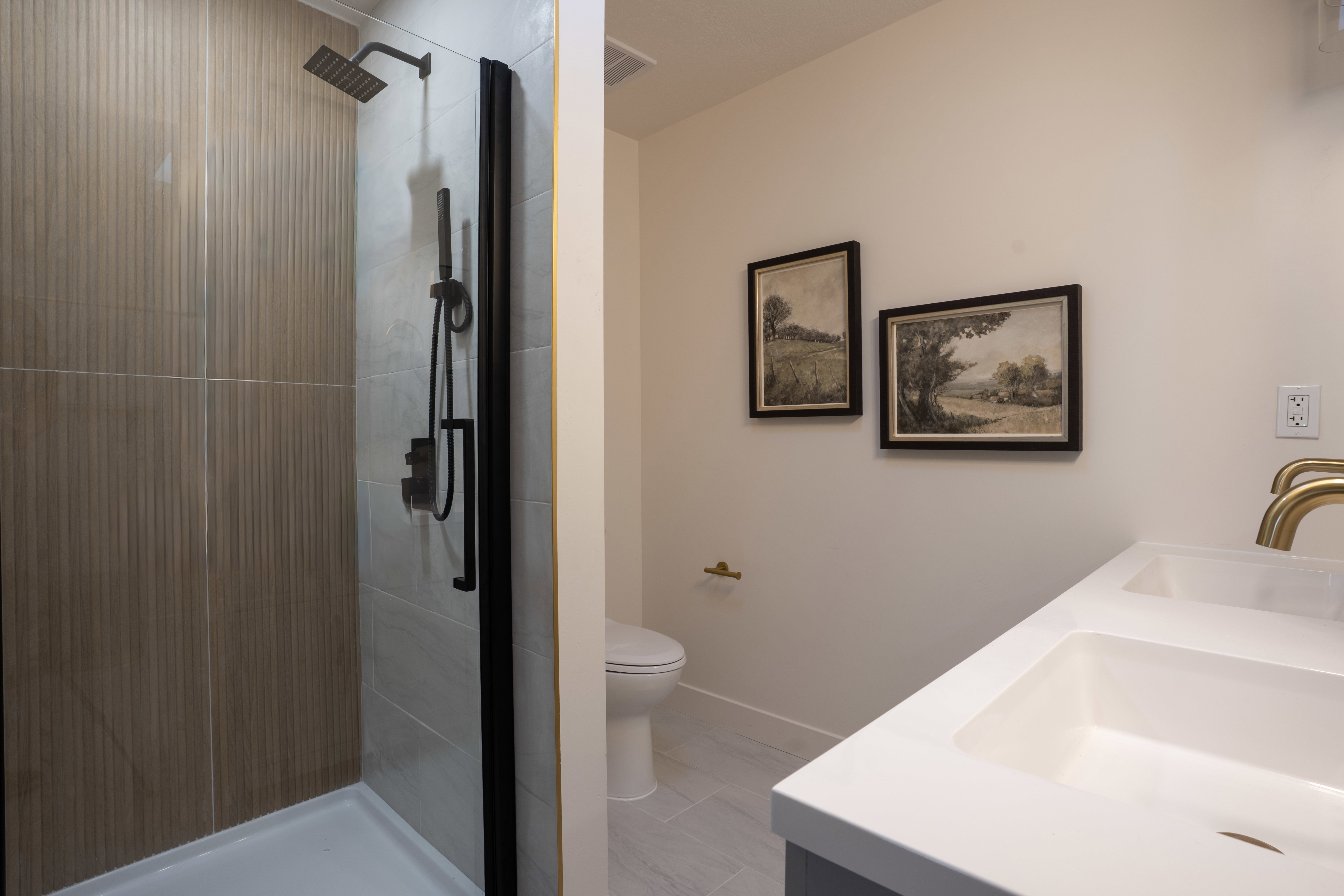Bathroom with double vanity and a stall shower