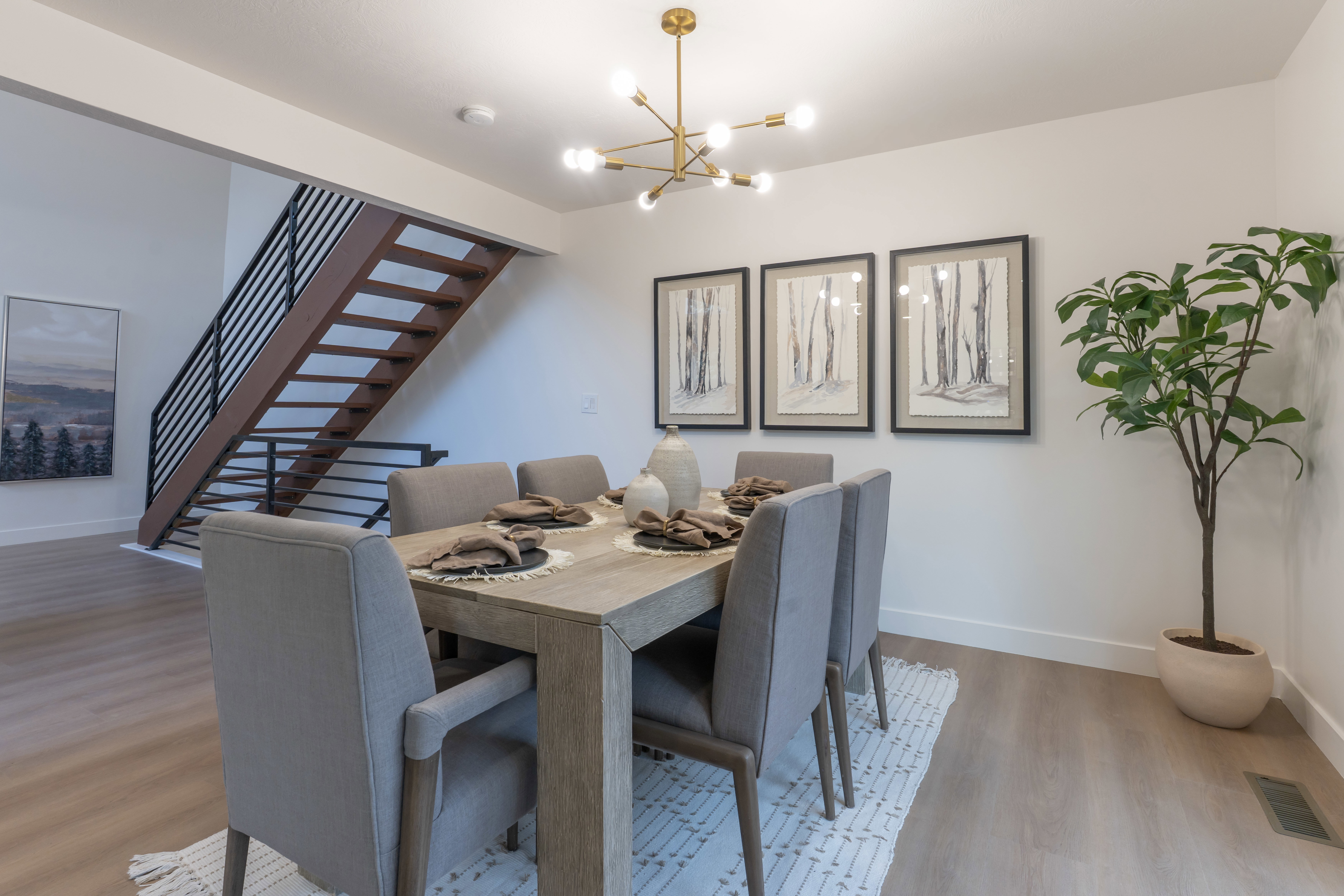 Dining space with light wood-style flooring and a chandelier