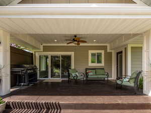Redwood deck with a ceiling fan, outdoor seating, and grilling area