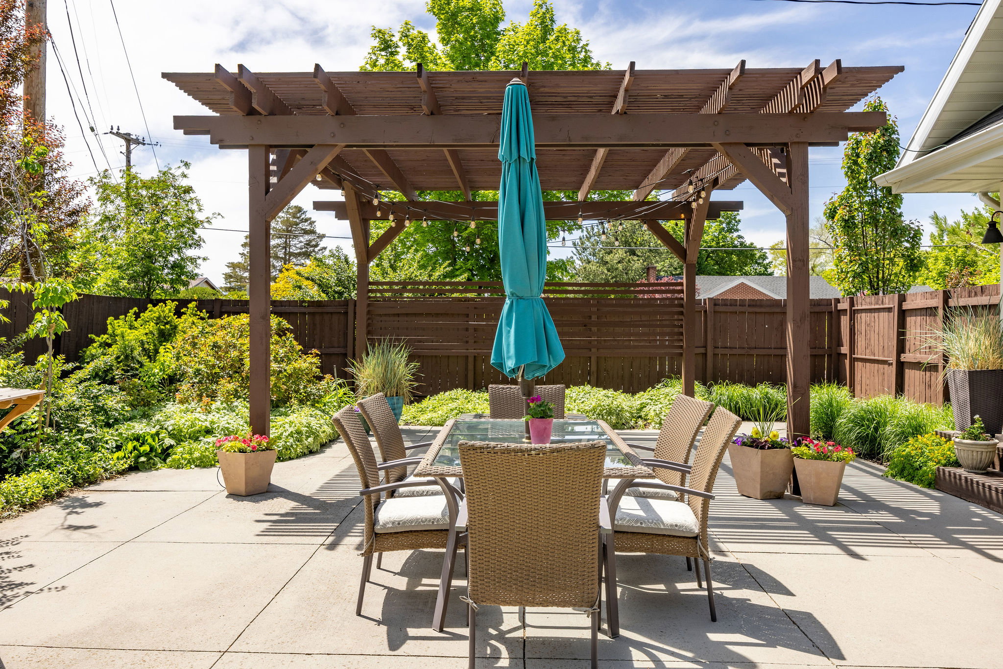 Fenced backyard with a patio, a pergola, and outdoor dining area