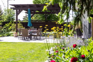 Fenced backyard with a patio area and outdoor dining space