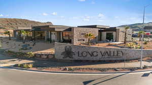 Community sign with a mountain view and a patio area