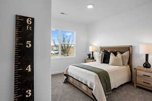 Bedroom with carpet flooring and baseboards