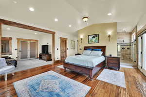 Bedroom featuring lofted ceiling and light wood-type flooring