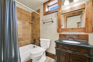 Full bathroom with vanity and shower / bathtub combination with curtain