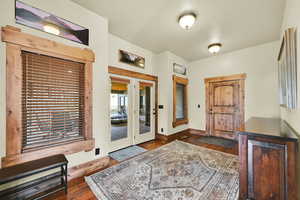 Entryway featuring dark wood-type flooring and baseboards