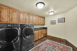 Laundry room featuring cabinet space and independent washer and dryer