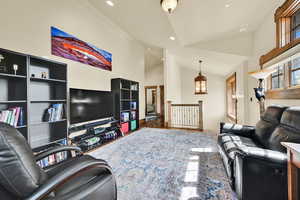 Living area with lofted ceiling, recessed lighting, and dark wood-type flooring