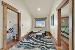 Sitting room with lofted ceiling, plenty of natural light, recessed lighting, and wood-type flooring