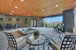 Deck with french doors and an outdoor hot tub