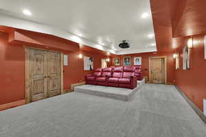 Carpeted home theater featuring recessed lighting