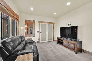 Living area featuring recessed lighting and light colored carpet