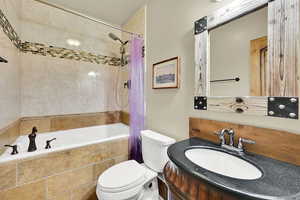 Bathroom featuring vanity and tiled shower / bath
