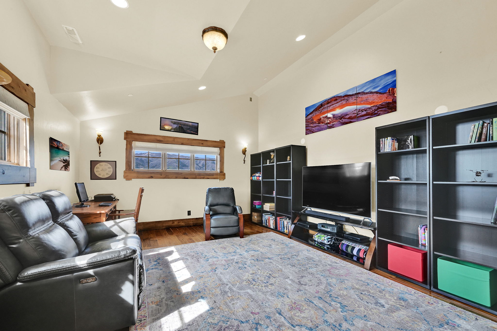 Living area with lofted ceiling, recessed lighting, and dark wood finished floors