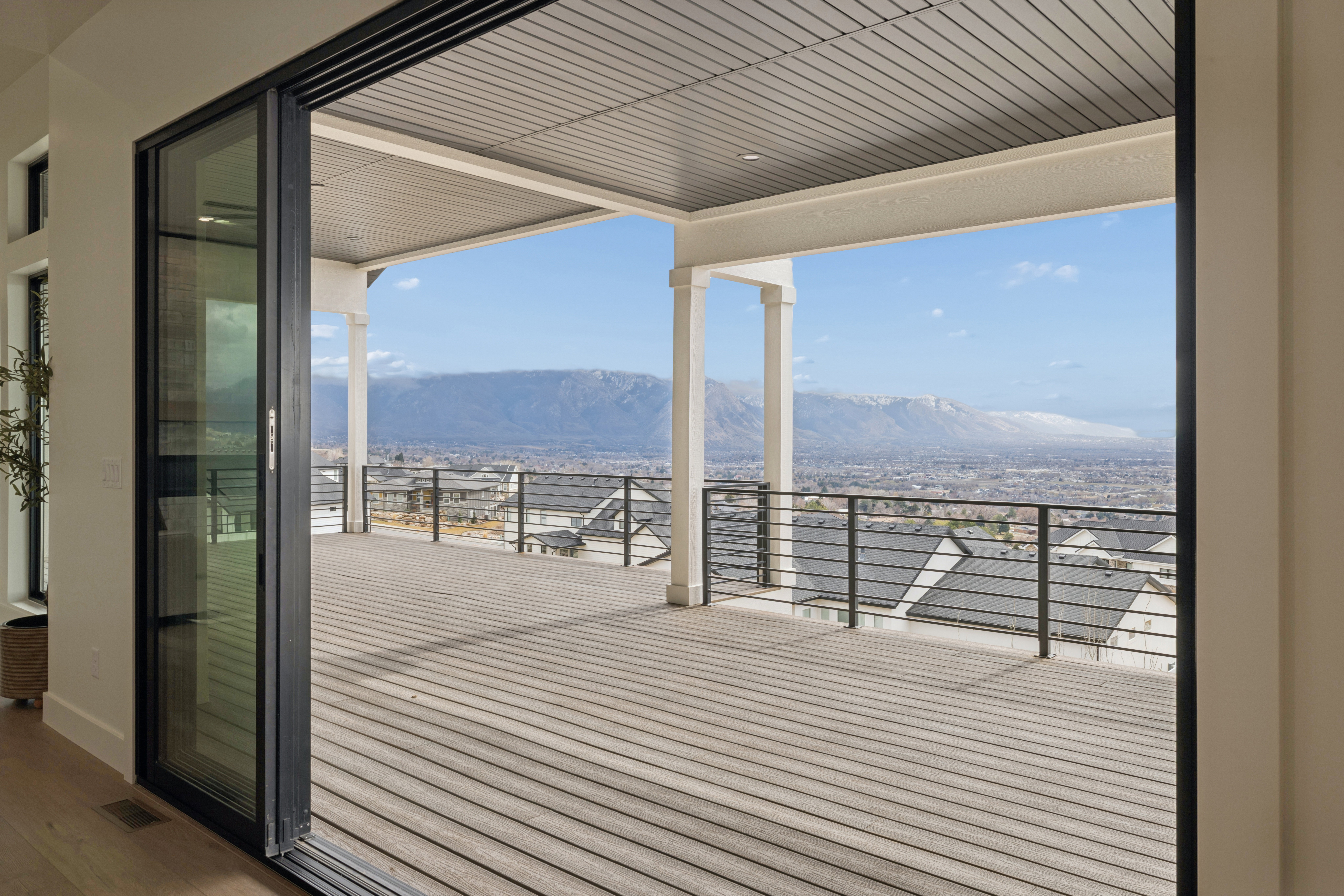 Wooden deck with a patio area and a mountain view
