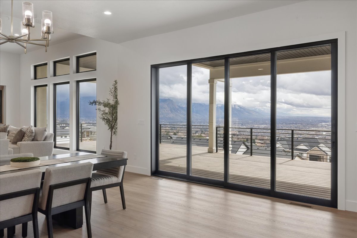 Dining room featuring a mountain view, a chandelier, and light wood-style flooring