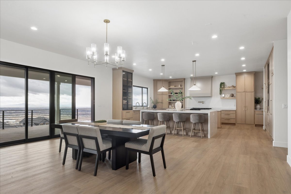 Dining space featuring light wood finished floors and suspended lighting