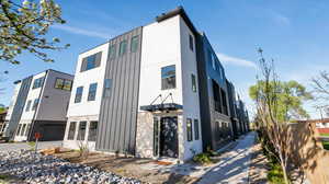 View of side of home featuring stone siding, board and batten siding, and stucco siding