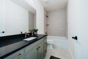 Bathroom featuring vanity, tub / shower combination, and light tile patterned floors