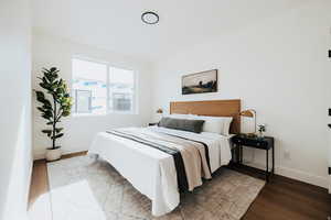 Bedroom with baseboards and light wood finished floors