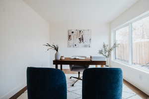 Office space with baseboards and light wood finished floors