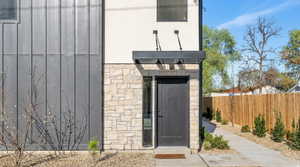 Doorway to property featuring stone siding