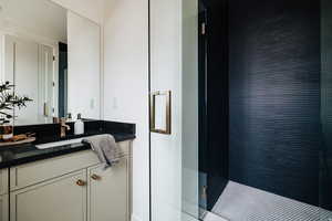 Full bathroom with vanity and a shower stall