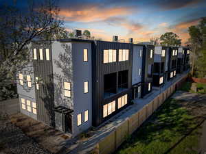 View of property at dusk