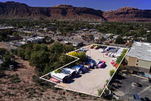 View of property location with a mountainous background, property boundaries highlighted, and nearby suburban area