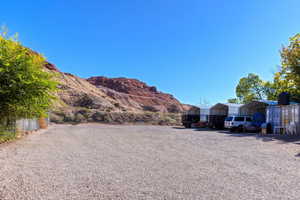 View of yard with a detached carport, a mountain view, and driveway