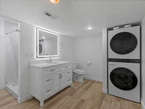 Basement bathroom with laundry and oversized shower.