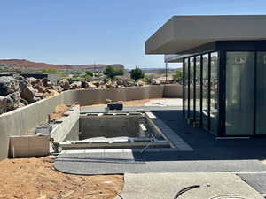 View of swimming pool featuring patio surround, a fenced backyard, and a mountain view