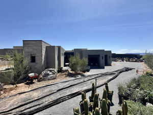 View of front of house with stucco siding, decorative driveway, a patio, and an attached garage