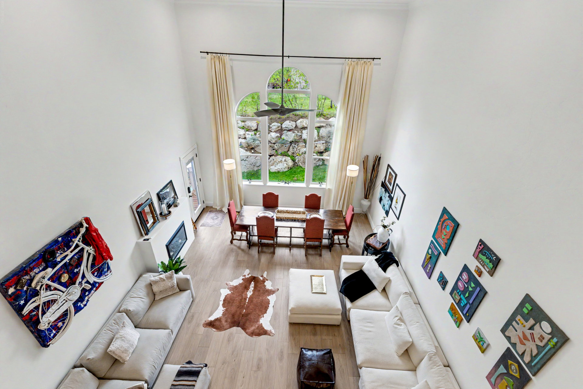 Living room featuring a high ceiling and wood finished floors