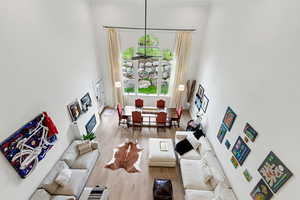 Living room featuring a high ceiling and wood finished floors
