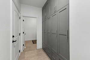 Hall with light wood finished floors