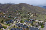 Aerial perspective of suburban area with a mountainous background