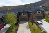 View of front facade with driveway, an attached garage, and a mountain view