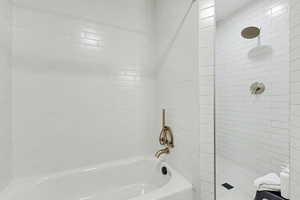 Bathroom with tiled shower and a garden tub