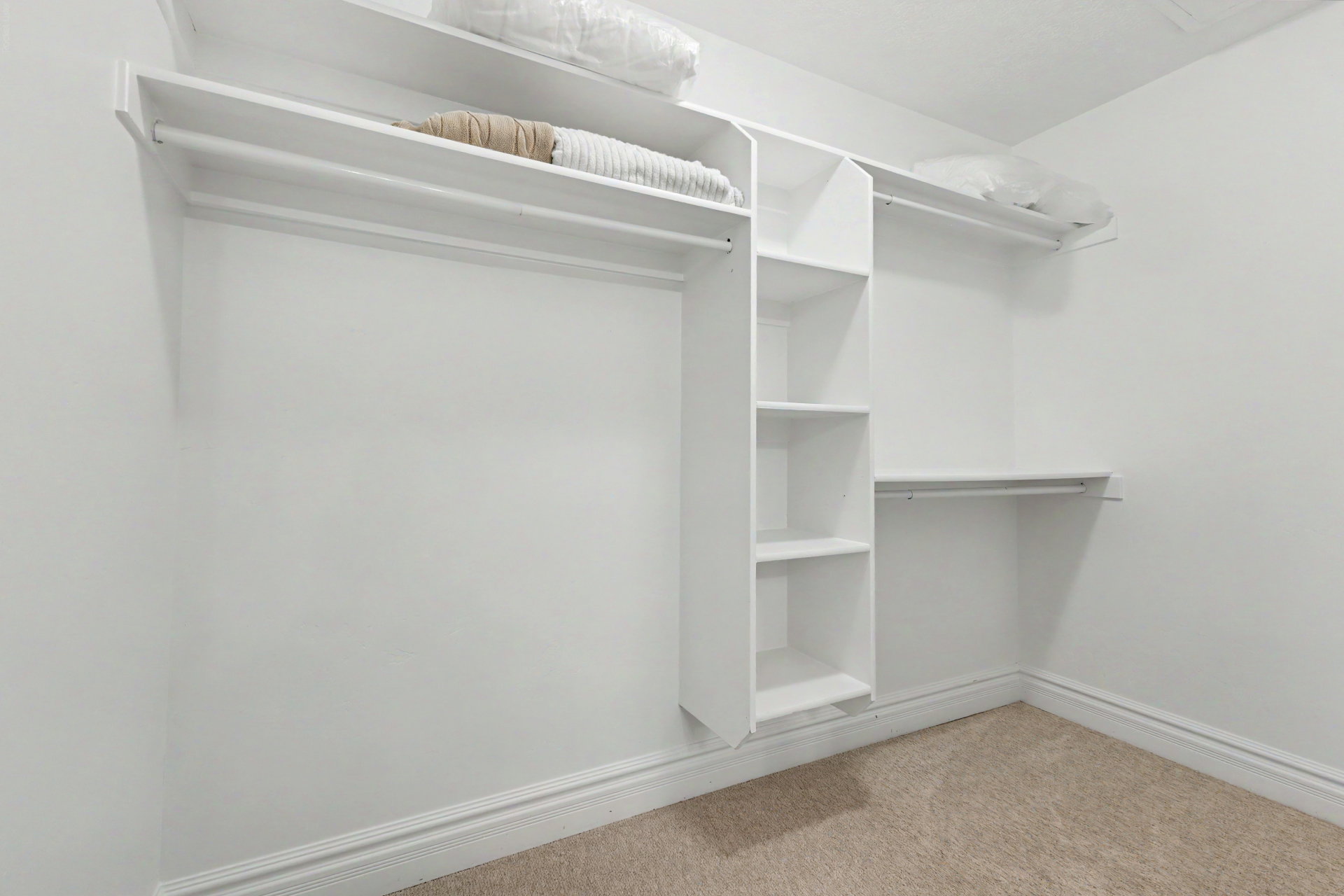 Walk in closet featuring light carpet