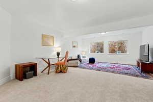 Sitting room with carpet floors and baseboards