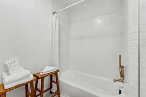 Bathroom featuring shower / bathtub combination with curtain