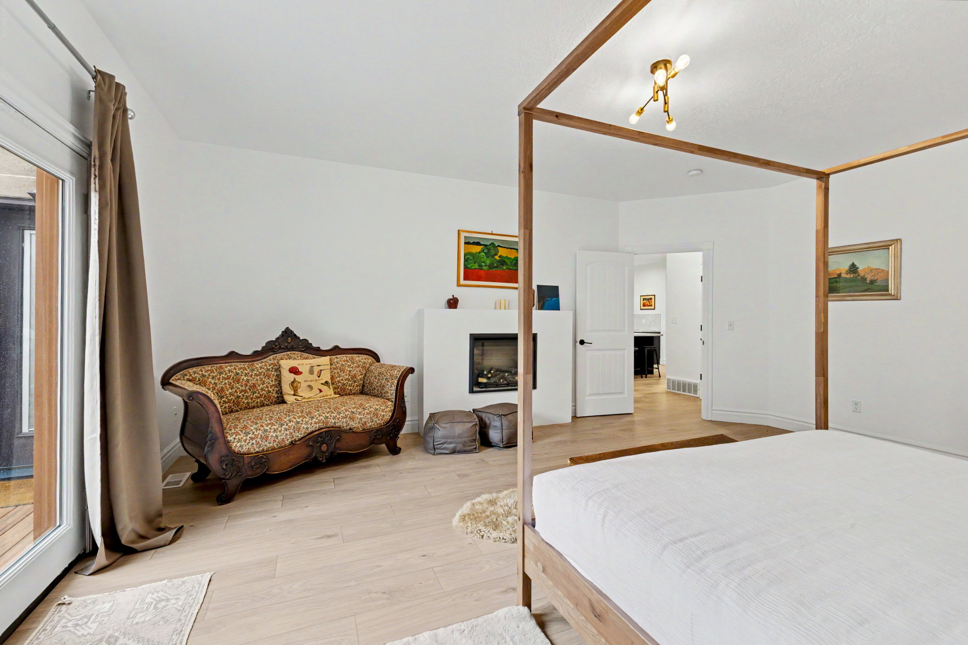 Bedroom with light wood-type flooring and a fireplace