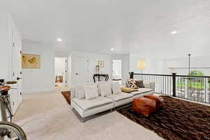 Living area featuring recessed lighting and light colored carpet