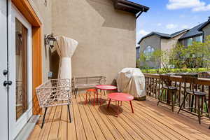 Wooden deck featuring area for grilling