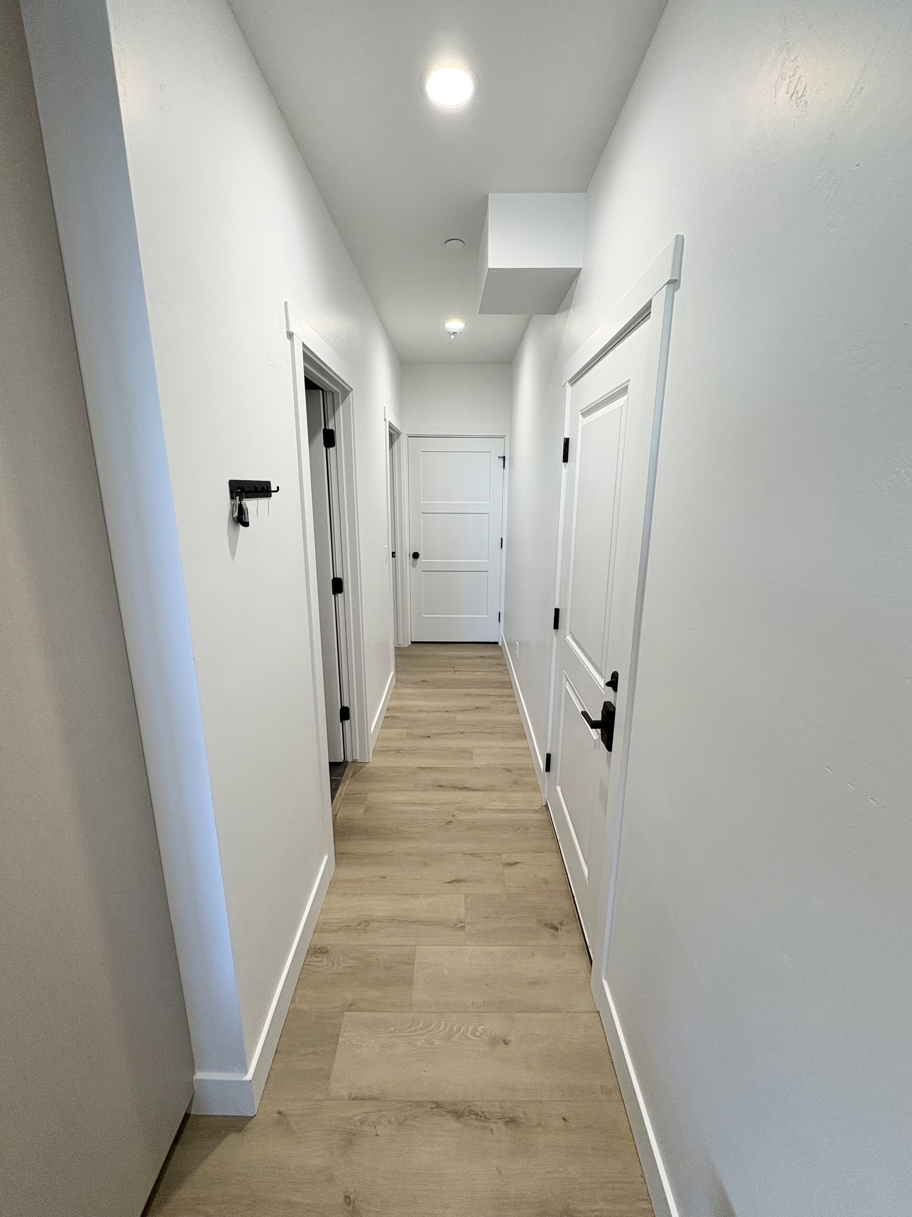 Hall featuring baseboards and light wood-style flooring